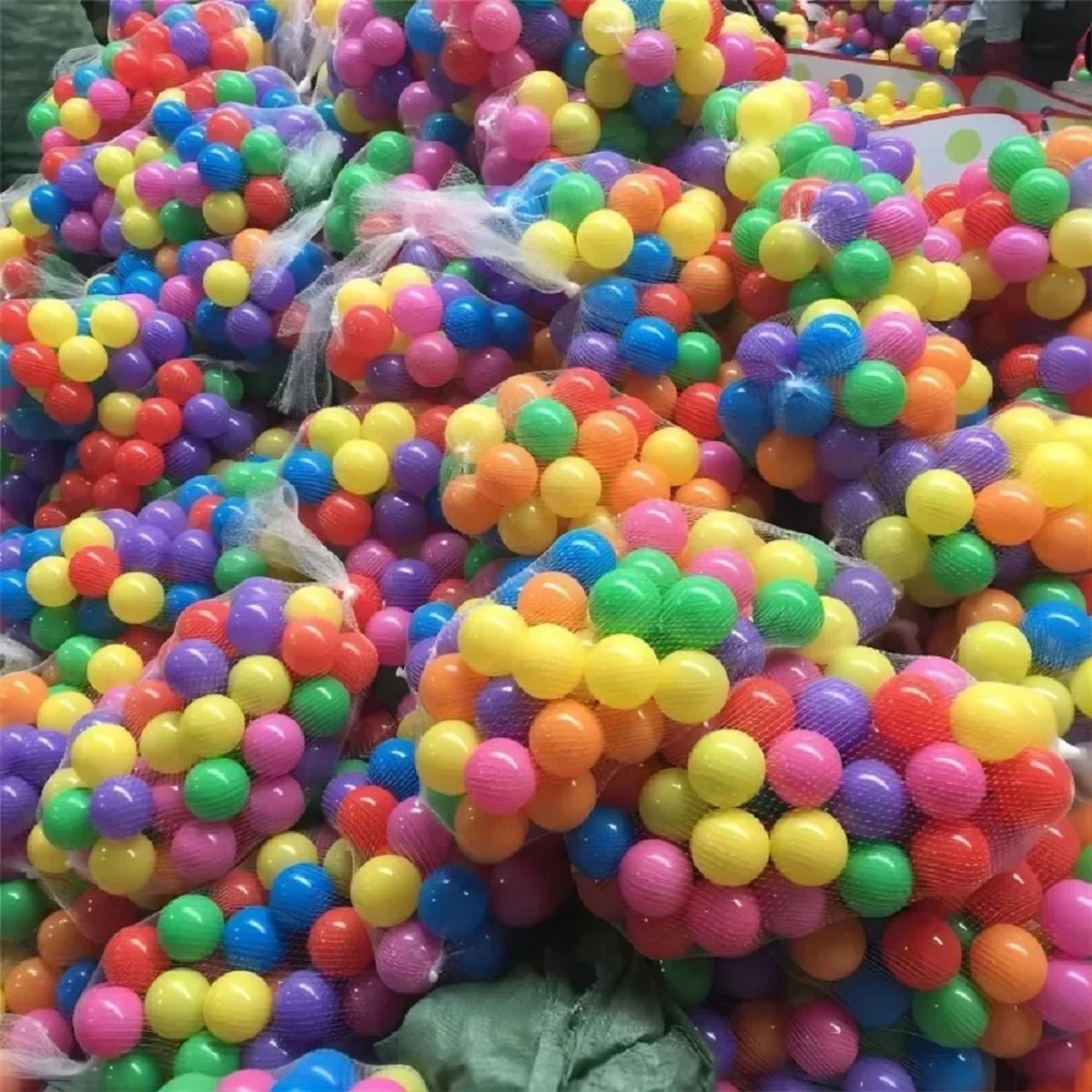 Mixed-color balls in mesh bags, ready to fill the pit