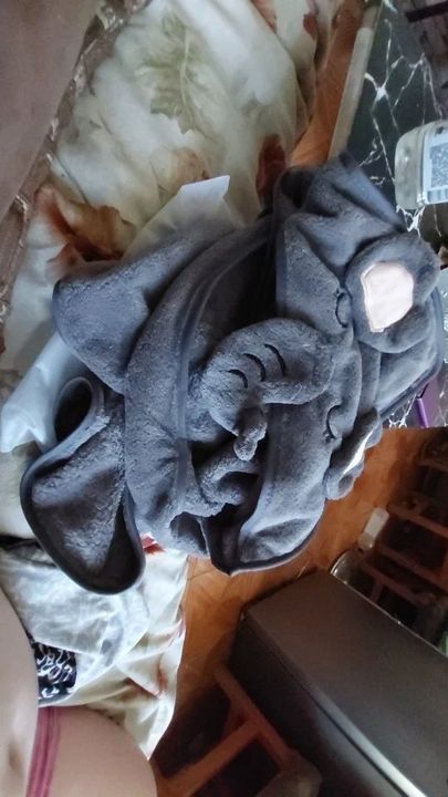 Customer photo: the hooded baby bath towel folded on a bed