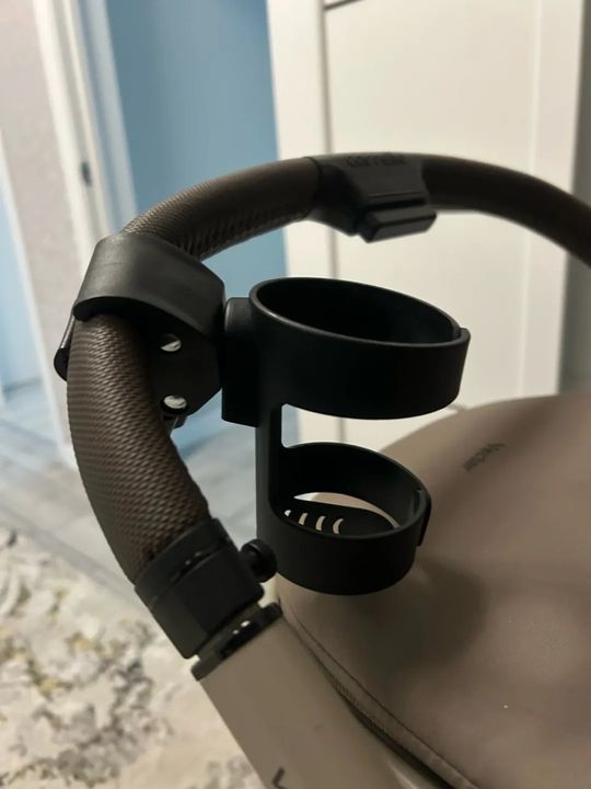 Customer photo: close-up of the stroller cup holder attached to a stroller handle