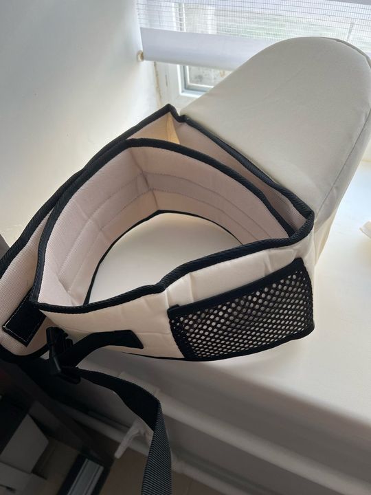 Customer photo: a cream and black hip seat carrier on a white windowsill