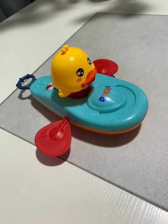 Customer photo: the duck kayak toy on a light grey surface