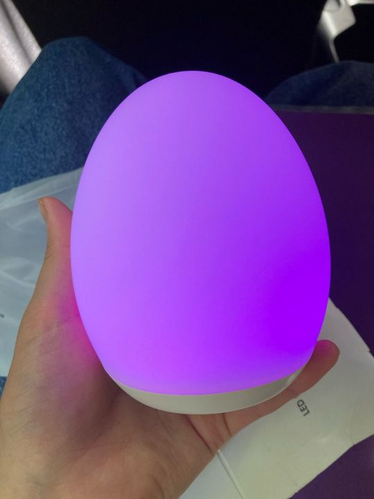 Customer photo: a hand holding the lamp glowing purple
