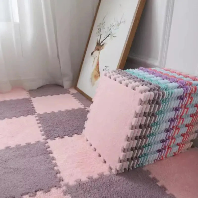 Plush Baby Floor Mat checkerboard in pink tones next to a tall stack of mixed-colour tiles