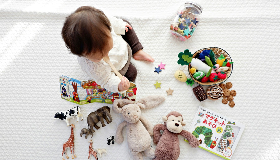 Baby surrounded by toys — gear overload