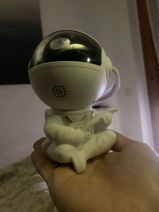 Customer photo: the astronaut projector held in a hand to show its size