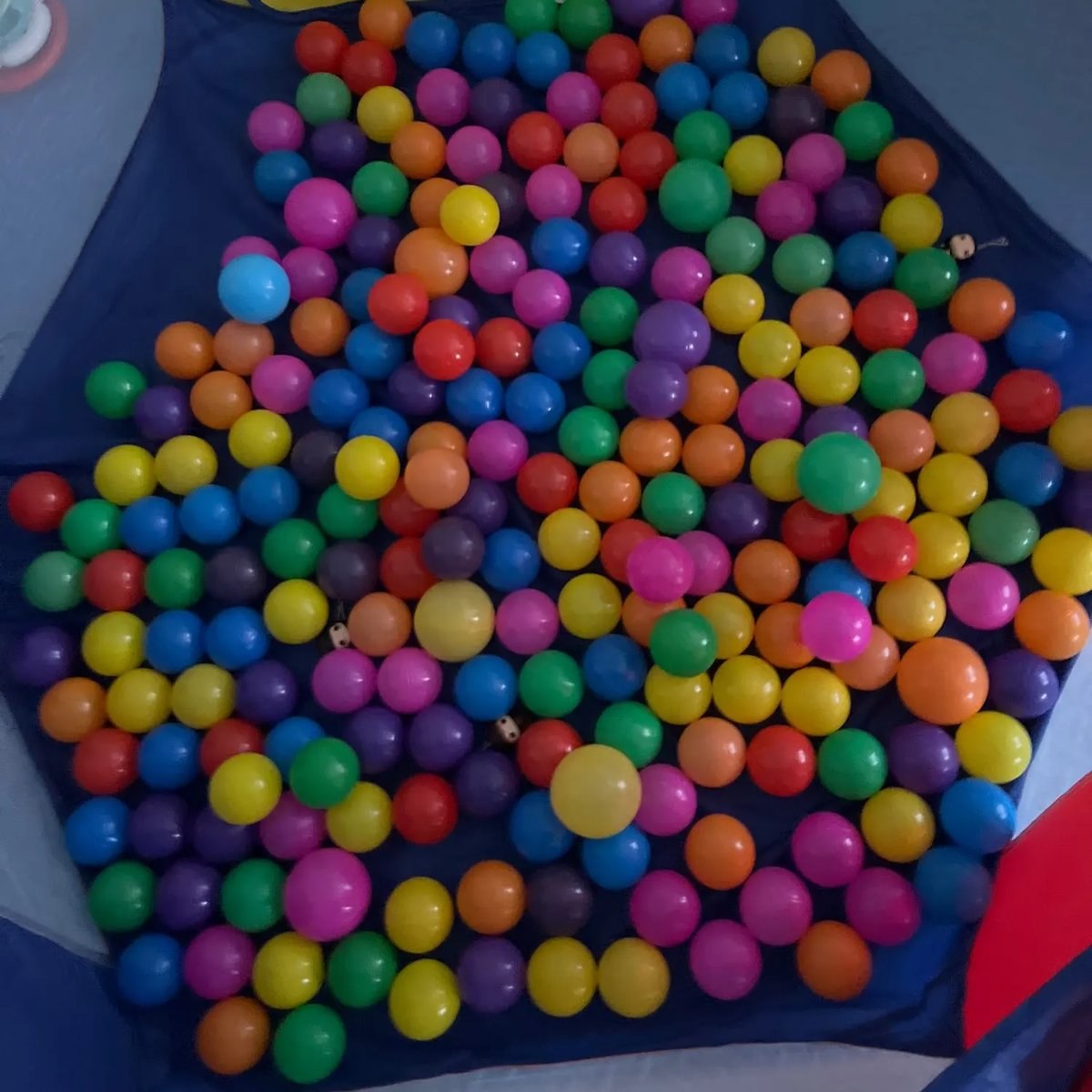 Mixed-color balls filling a play tent