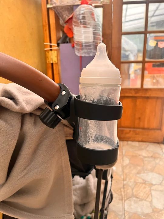 Customer photo: a baby bottle in the stroller cup holder