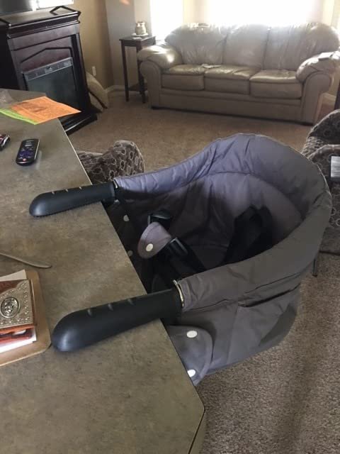 Customer photo: the grey clip-on dining chair attached to a counter edge