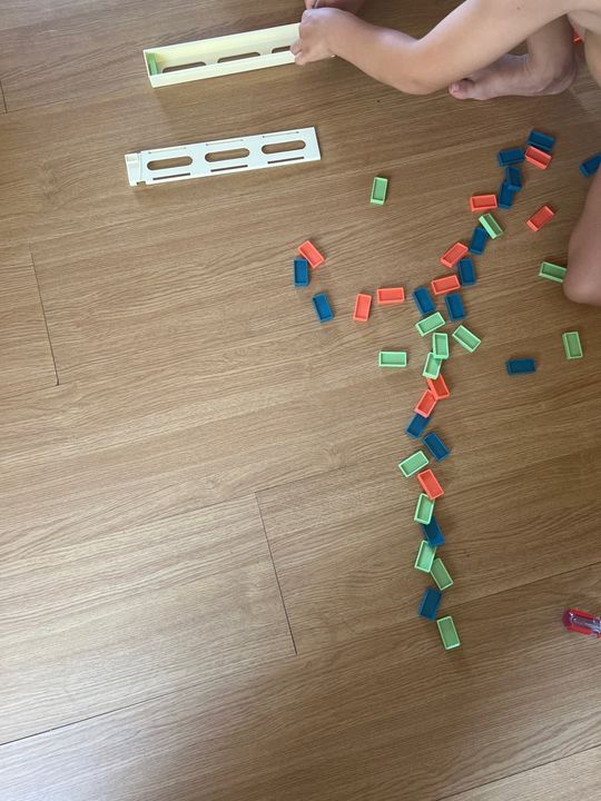 Customer photo: dominoes and cartridges spread out on the floor during play