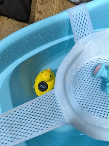 Customer photo: the duck bath thermometer floating in a baby bath tub