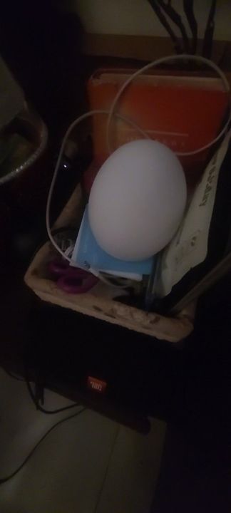 Customer photo: the lamp glowing white inside a storage basket
