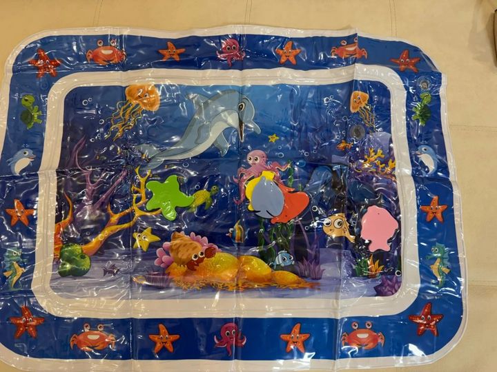 Customer photo: the inflatable water play mat laid flat on a floor