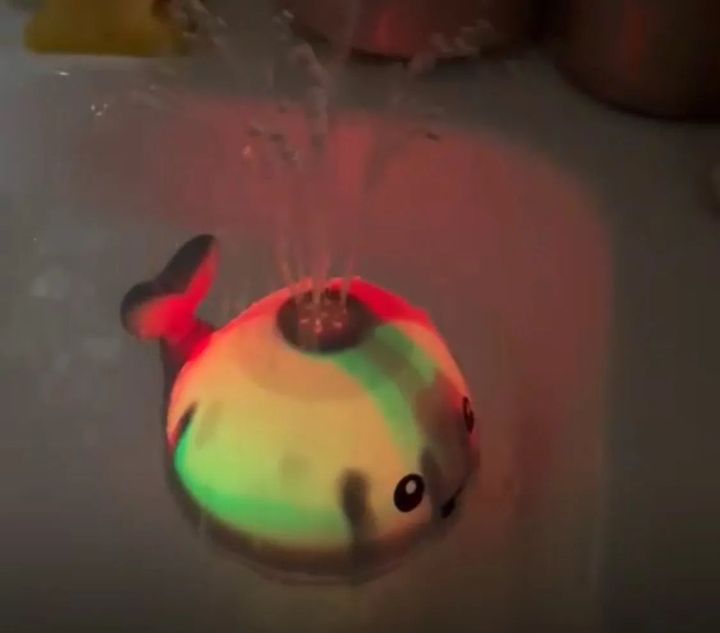 Customer photo: close-up of the whale sprinkler toy lit up and spraying water