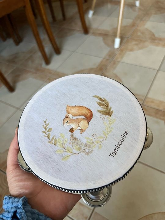 Customer photo: a hand holding the wooden Tambourine